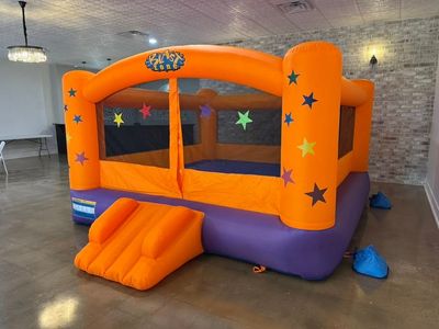 Orange and purple star bounce house set up at Paris Venue