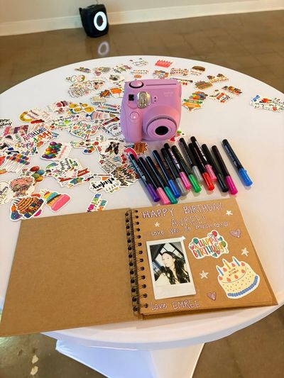Birthday guest book station with an instant camera and stickers