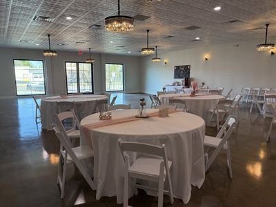 Birthday party with round tables dressed in blush runners