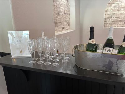 Champagne flutes and sparkling wine ready at the bar