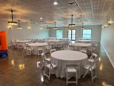 Paris Venue ballroom set with white round tables and natural light