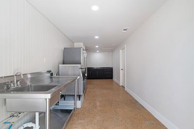 Catering prep area with sink and stainless steel counters