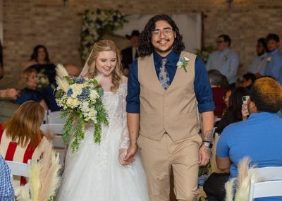 Newlyweds walk the aisle during their recessional
