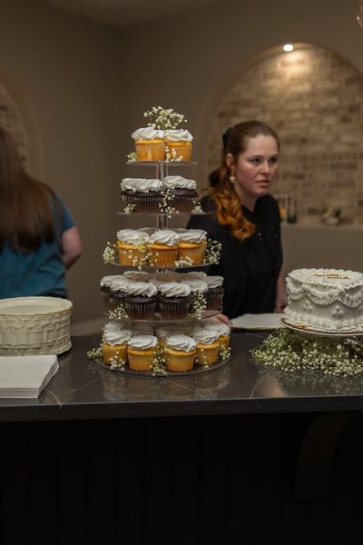 Wedding cupcake tower accented with baby's breath