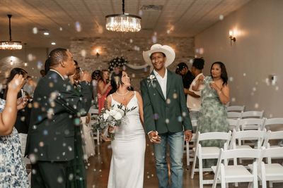 Wedding recessional as guests blow bubbles for the couple